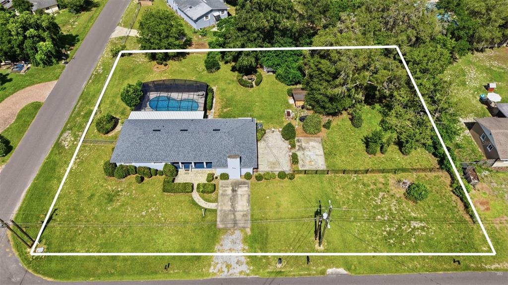An aerial view shows a house with a pool enclosure on a large grassy lot — 790 S BOUNDARY AVENUE, DELAND, FL
