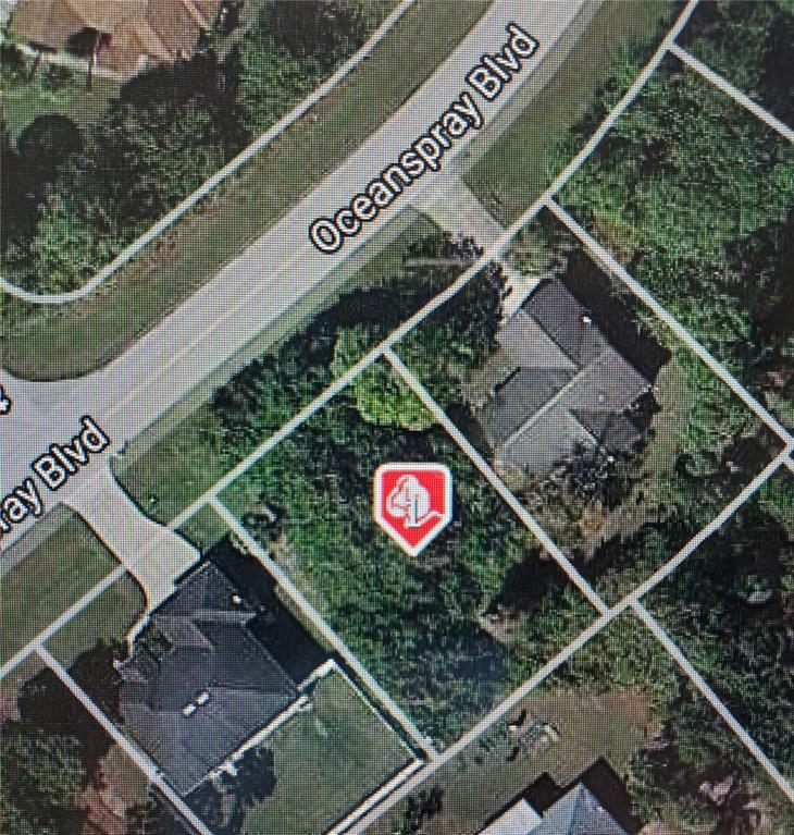 This is an aerial map showing a vacant residential lot located between two existing houses — 11325 OCEANSPRAY BOULEVARD, ENGLEWOOD, FL