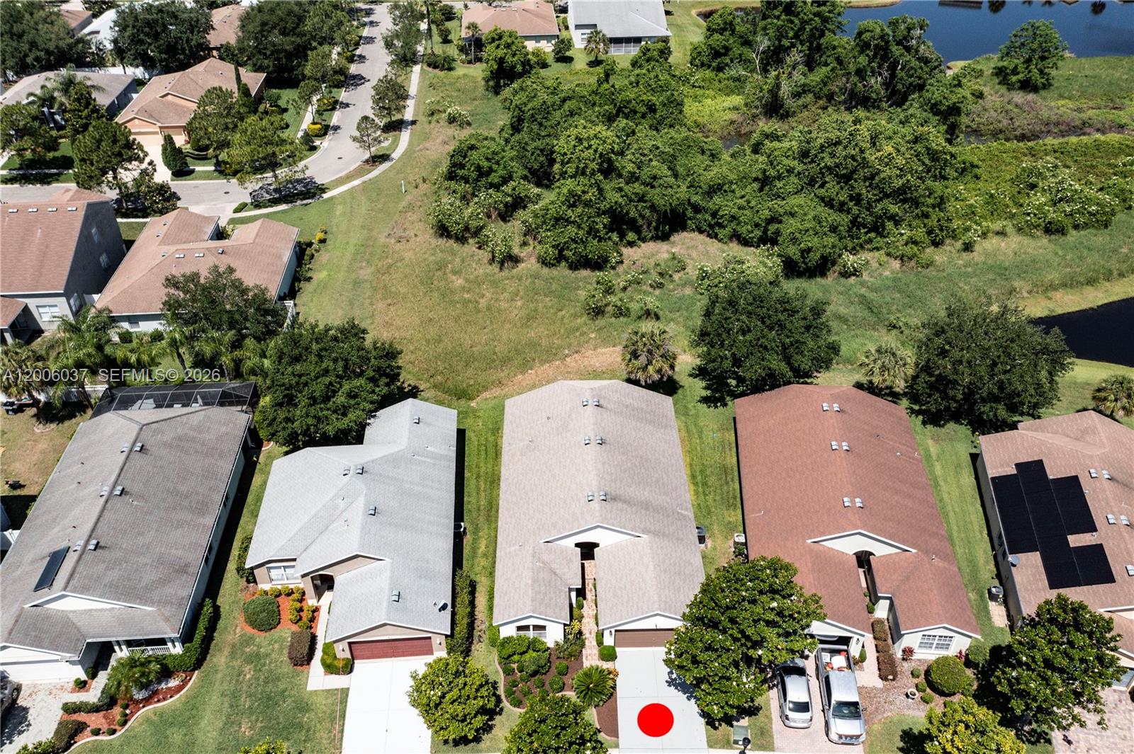 An aerial view shows a suburban street with three houses and a red dot on a driveway — 11413 MOUNTAIN BAY DR, Riverview FL 33569, RIVERVIEW, FL