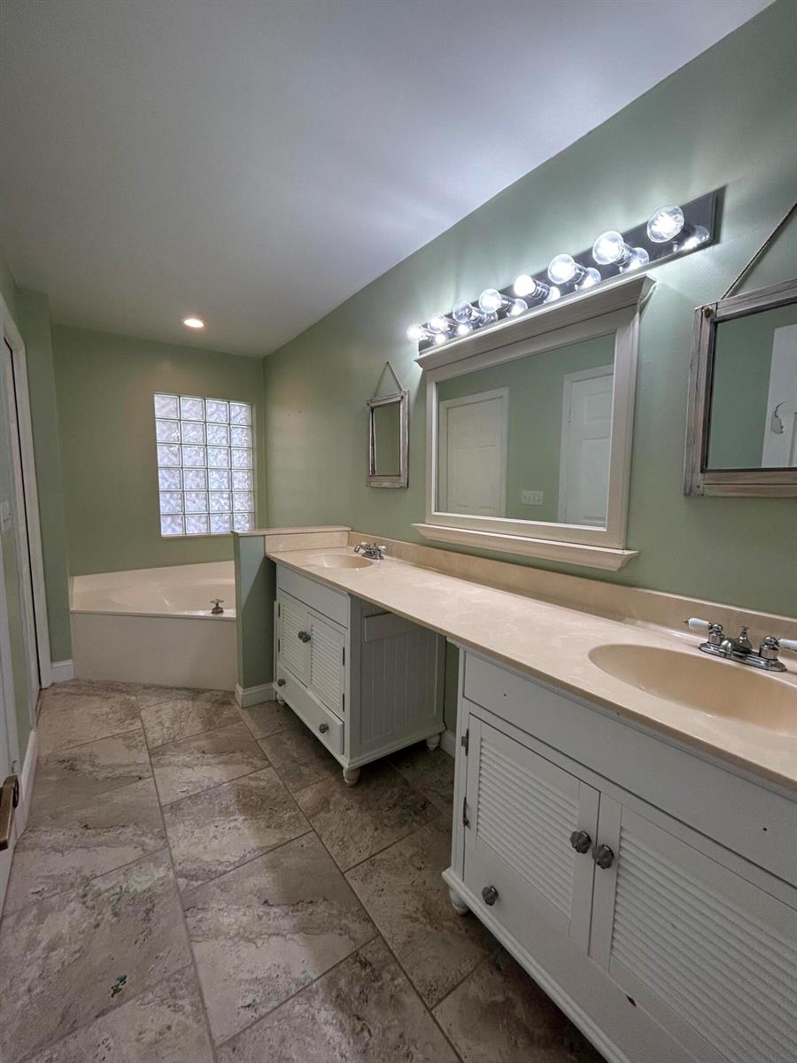 A room with light green walls, tile flooring, two windows with blinds, and several furniture pieces — 6376 Breckenridge Circle, Lake Worth FL 33467, LAKE WORTH, FL