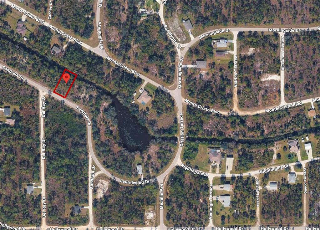 This is an aerial map view of a vacant residential lot highlighted in red — 27502 SANDRALA DRIVE, PUNTA GORDA, FL