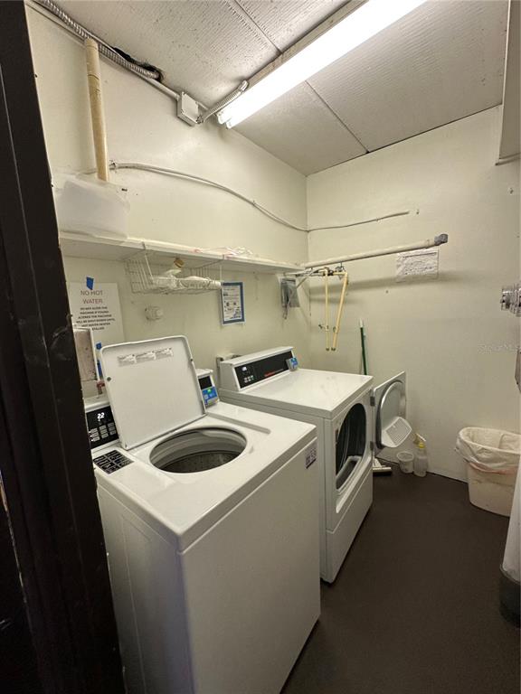A laundry room features a top-load washer, a front-load dryer, and a white shelf — 4826 MARINE PARKWAY UNIT 202, NEW PORT RICHEY, FL