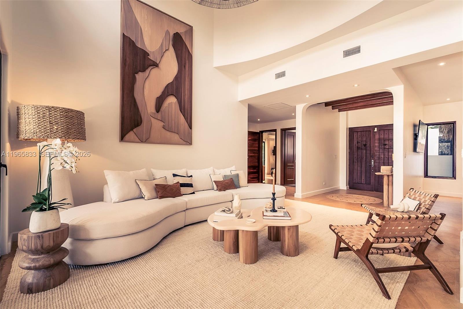 A living room features a curved white sofa, wooden coffee table, and large wall art — 90 Reserva De Golf, IA 50319, IA