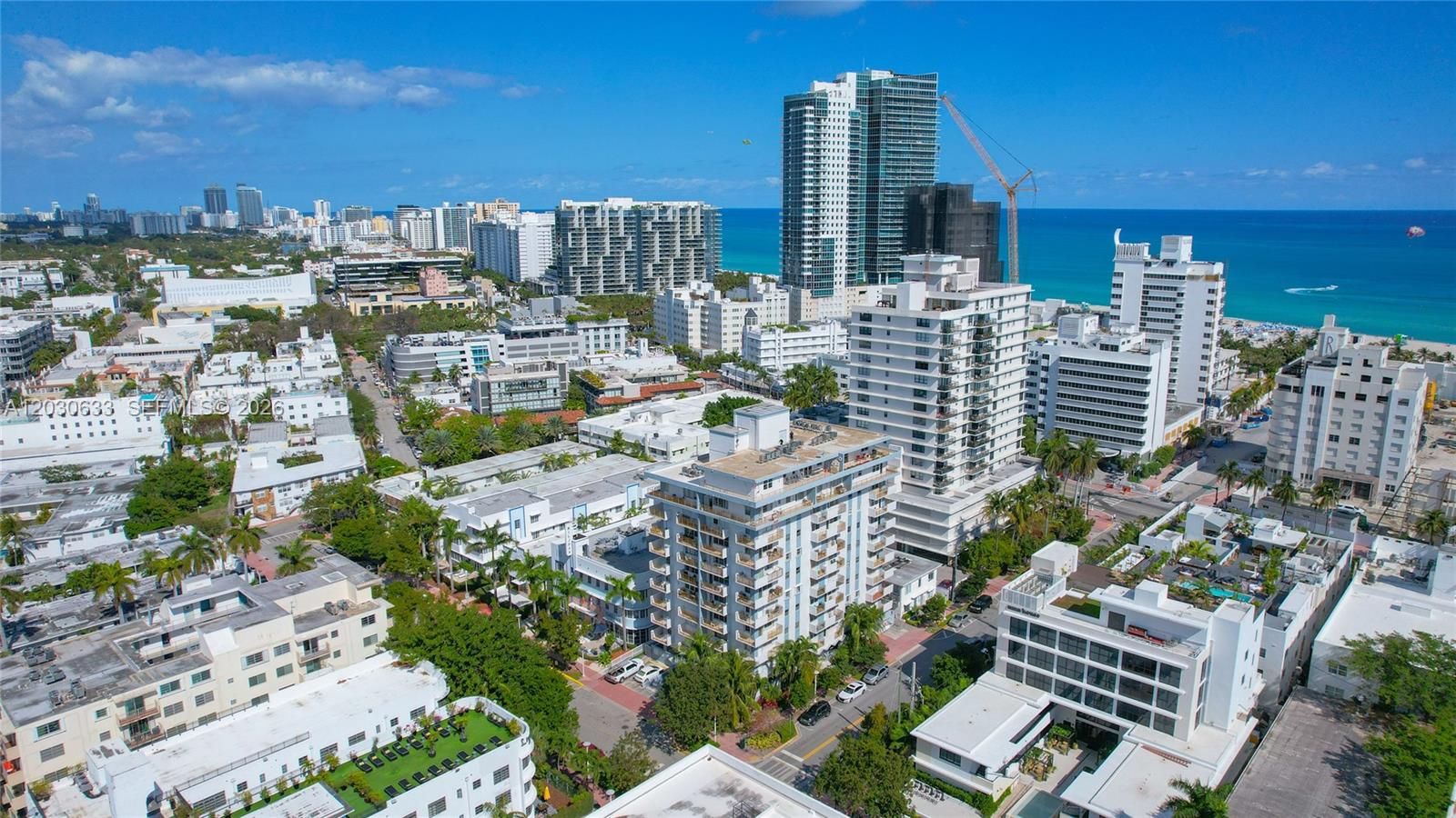An aerial view shows a dense urban neighborhood with mid-rise buildings near the ocean — 245 18th St # 605, Miami Beach FL 33139, MIAMI BEACH, FL