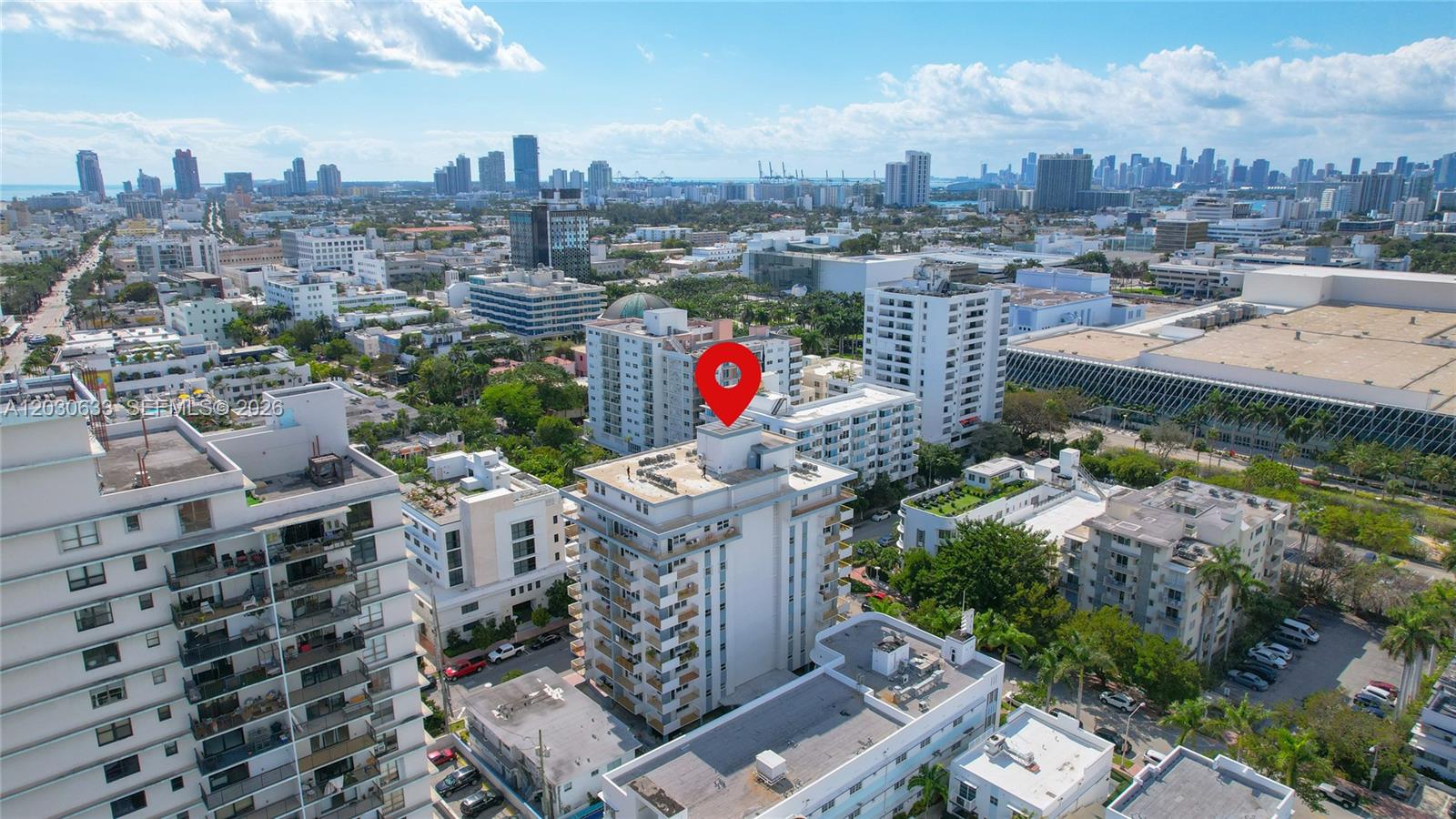 An aerial view shows a multi-story white residential building marked with a red location pin — 245 18th St # 605, Miami Beach FL 33139, MIAMI BEACH, FL