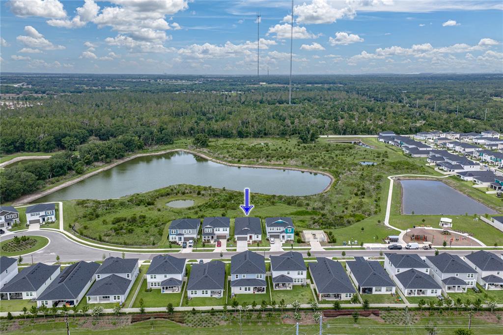 An aerial view shows a single-family home with a blue arrow pointing to its roof — 12253 CATTLESIDE DRIVE, RIVERVIEW, FL