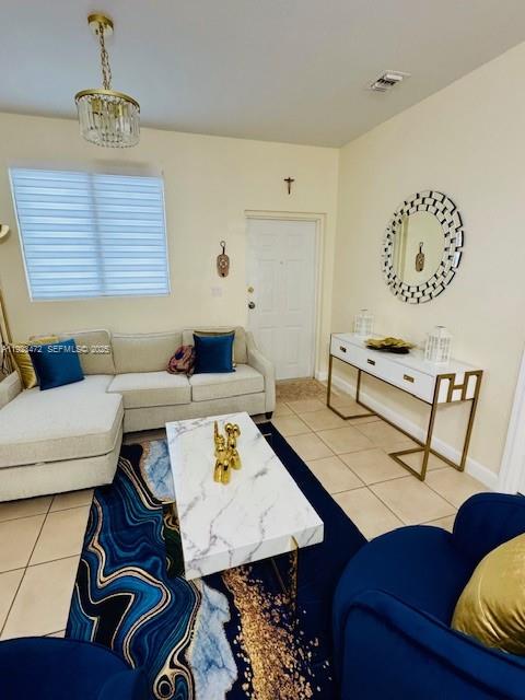 A living room features a beige sectional sofa, a marble coffee table, and a blue rug — 2811 SE 17th Ave # 110, Homestead FL 33035, HOMESTEAD, FL