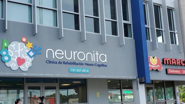 The exterior of a commercial building features signage for a neuro-cognitive clinic and a pizza restaurant — 1 PR-1 INT. SAKURA ST., CAGUAS, PR