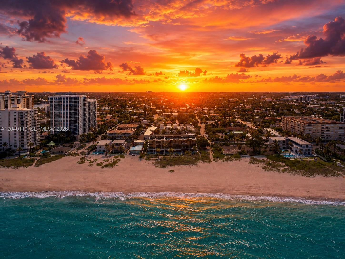 An aerial view of a beach, residential buildings, and a sunset over the horizon — 3406 SE 6th St # 3406, Pompano Beach FL 33062, POMPANO BEACH, FL