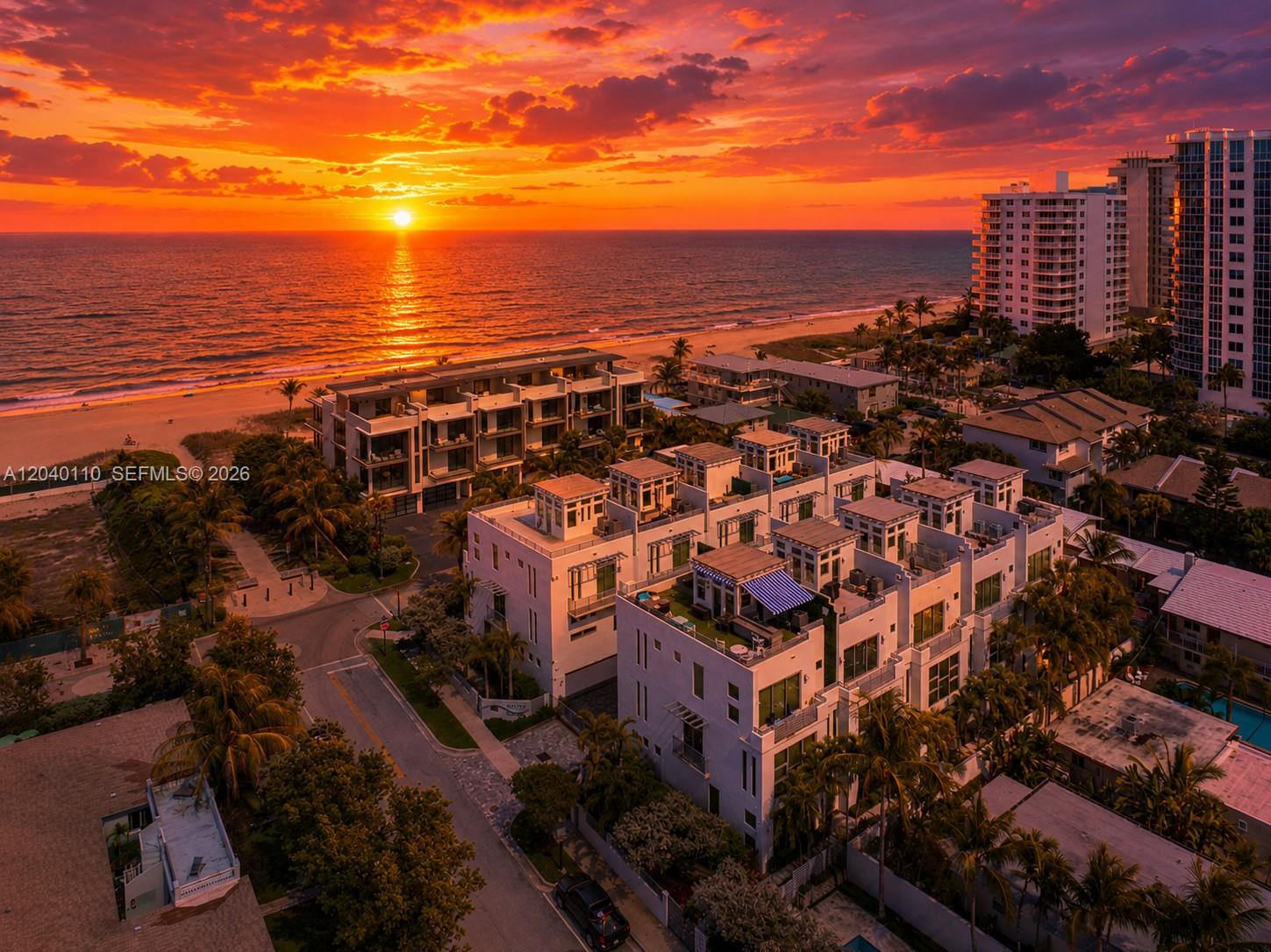 An aerial view of modern townhomes near a beach at sunset with high-rise buildings nearby — 3406 SE 6th St # 3406, Pompano Beach FL 33062, POMPANO BEACH, FL