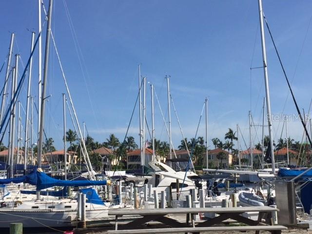 A marina filled with sailboats and yachts sits in front of residential houses — 17947 COURTSIDE LANDINGS CIRCLE, PUNTA GORDA, FL
