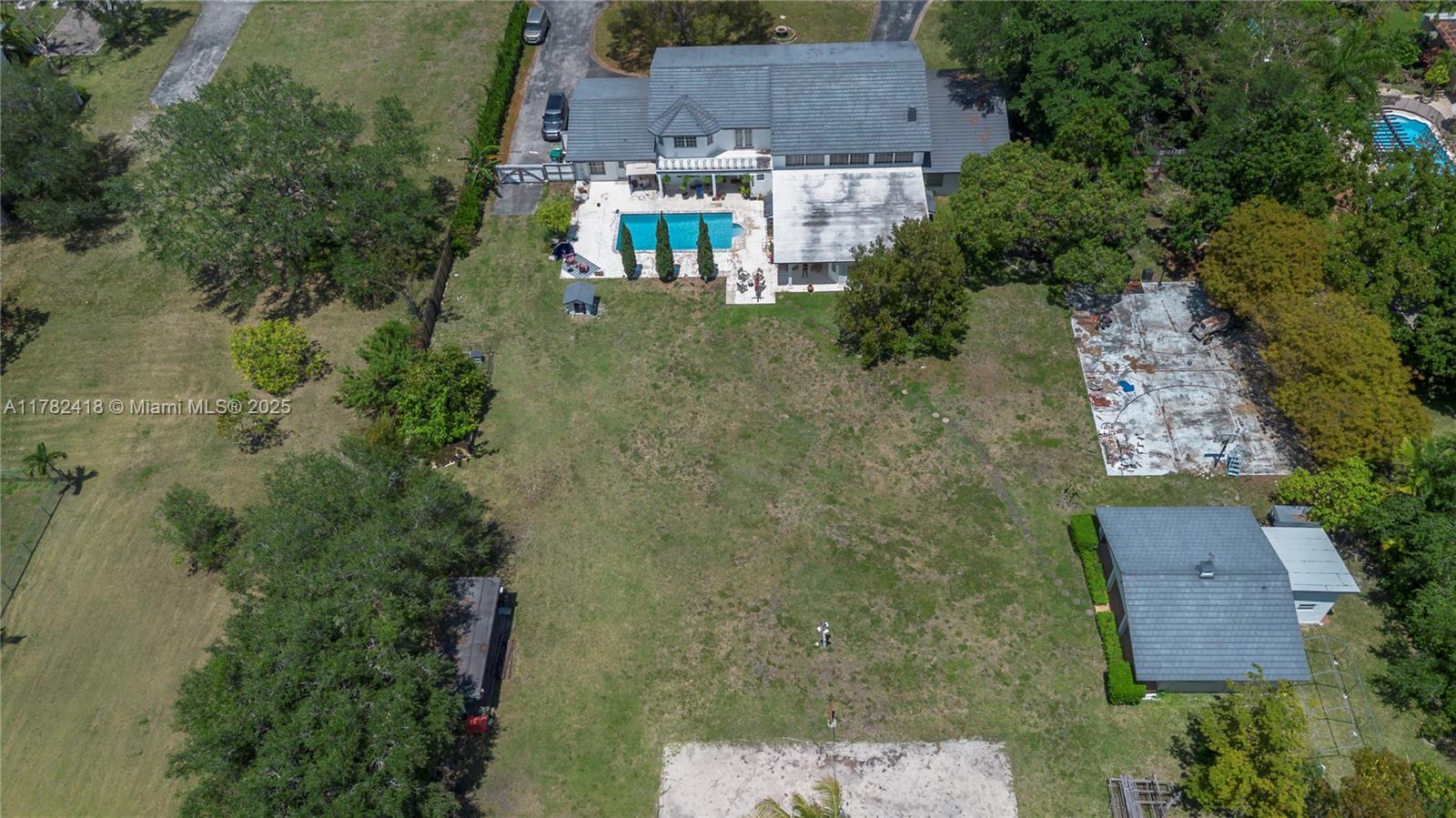 An aerial view shows a house with a pool, a large yard, and a detached building — 8350 SW 98 th St, Miami FL 33156, MIAMI, FL