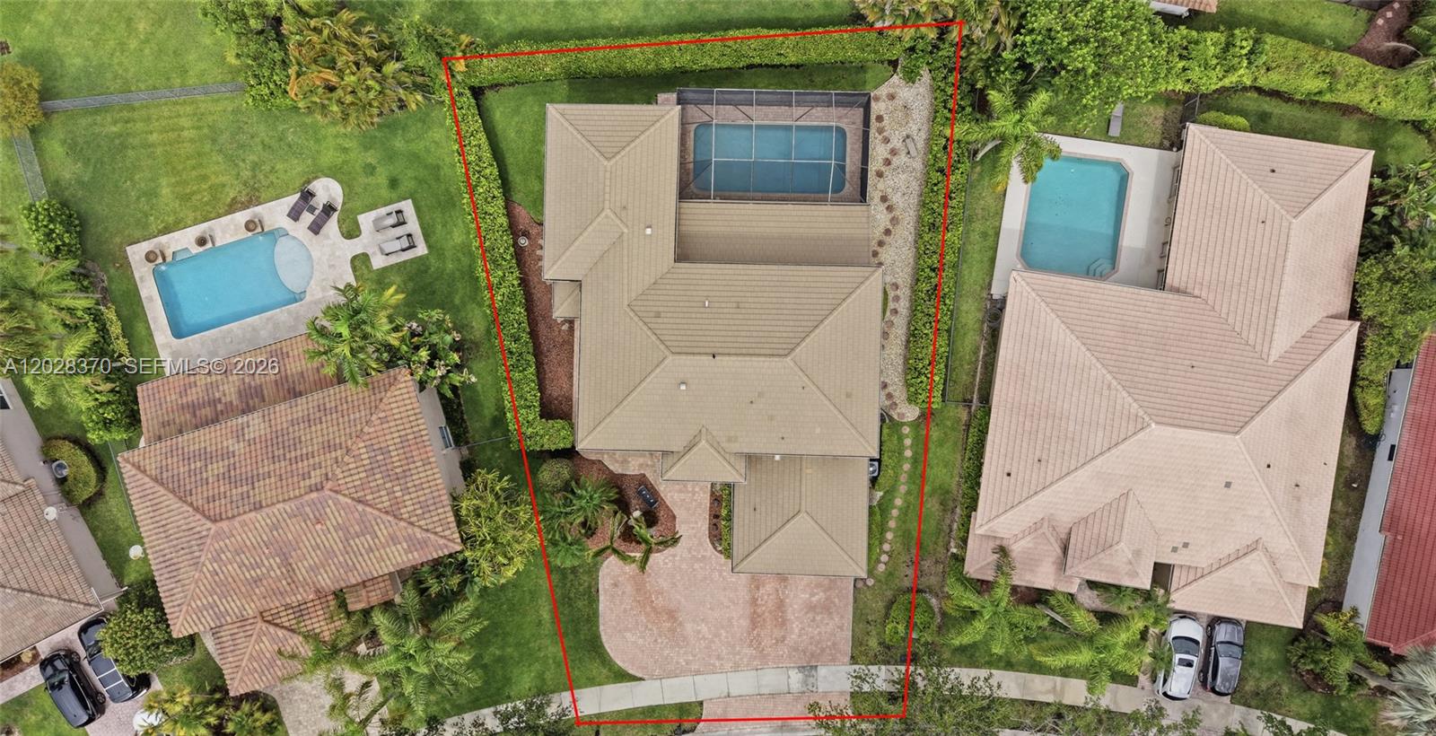 An aerial view shows a house with a screened pool and a paved driveway — 2608 Oakbrook Ct, Weston FL 33332, WESTON, FL