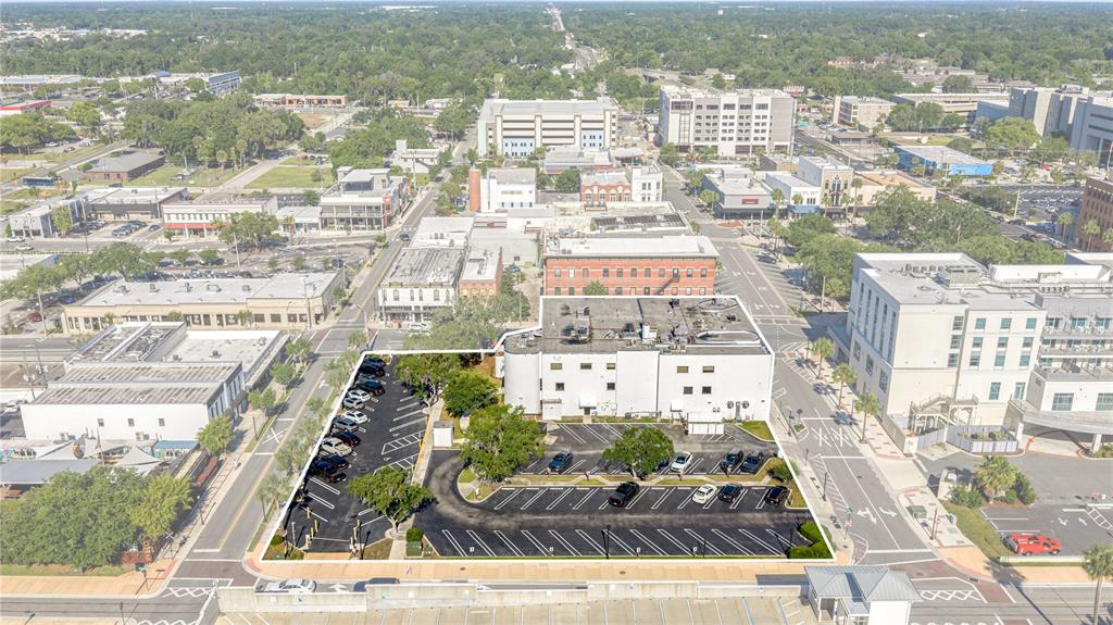 An aerial view shows a commercial building with a large parking lot in a city — 35 SE 1ST AVENUE 2nd Floor, OCALA, FL