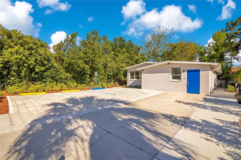A paved parking area with three marked spaces sits in front of a light-colored building — 4749 HARGRAVE STREET, ORLANDO, FL