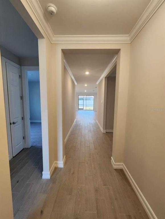 A hallway with light-colored tile flooring leads toward a glass door at the far end — 333 VILLORESI BOULEVARD, NOKOMIS, FL