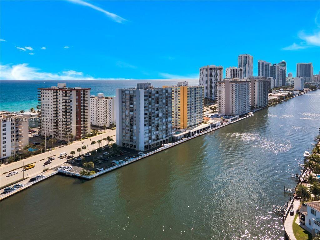 An aerial view shows several high-rise apartment buildings situated along a canal near the ocean — 1400 S Ocean Dr # 1004, Hollywood FL 33019, HOLLYWOOD, FL