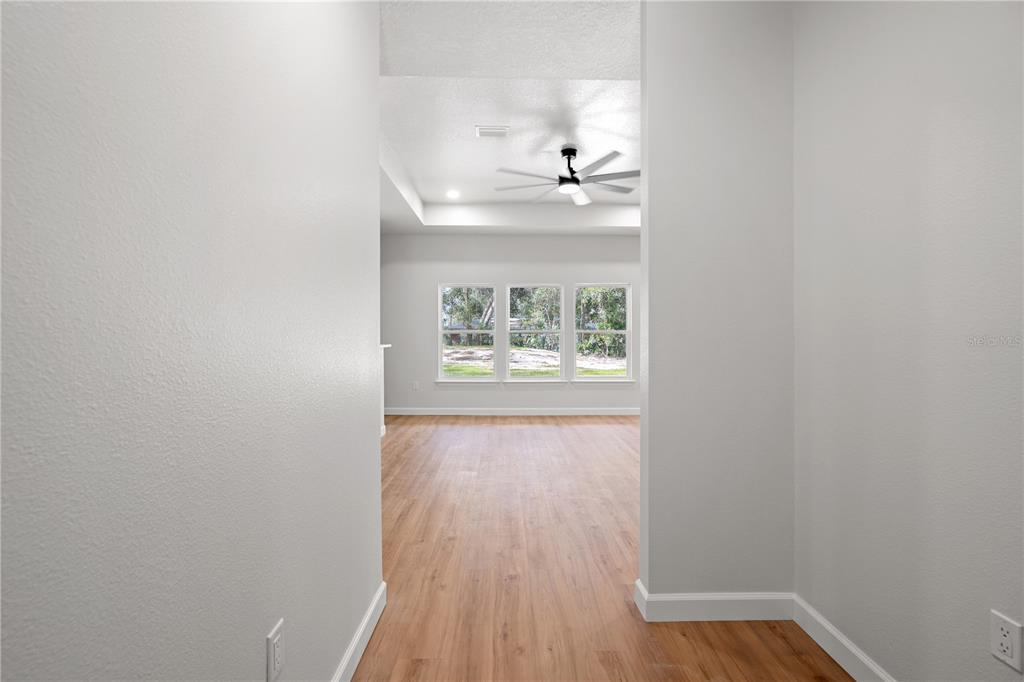 An aerial view shows a new house with a driveway on a wooded residential lot — 11380 NW 92ND CT, CHIEFLAND, FL