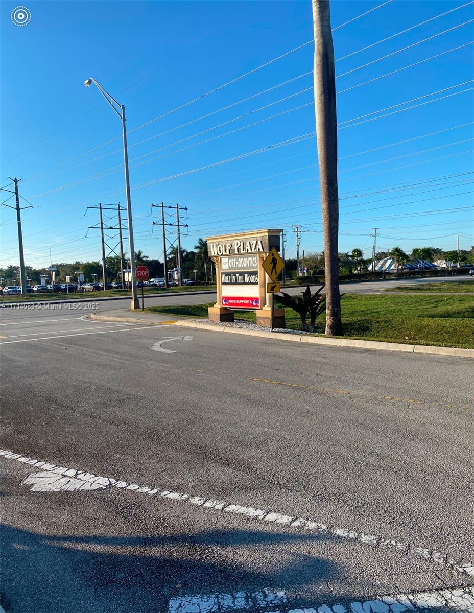 A sign for Wolf Plaza stands at the corner of a paved road intersection — 5360 S University Dr, Davie FL 33328, DAVIE, FL