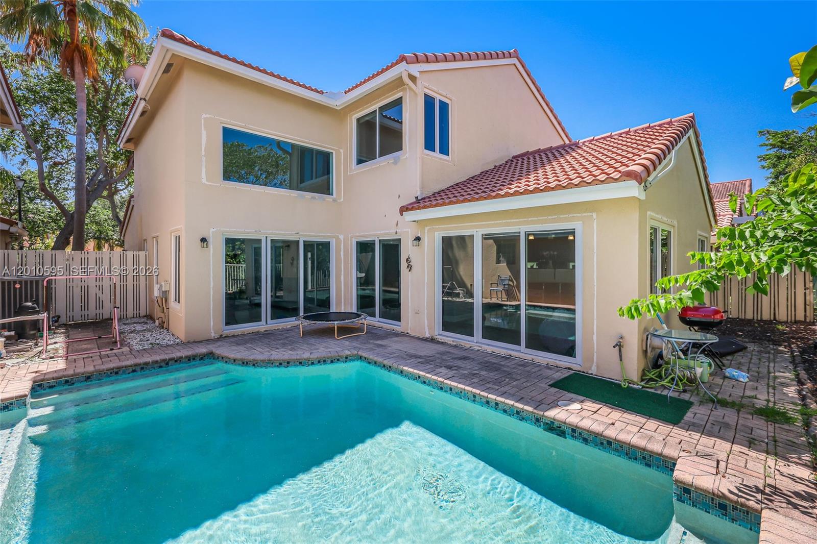A two-story house with a backyard swimming pool and a paved patio area — 1065 Weeping Willow Way, Hollywood FL 33019, HOLLYWOOD, FL