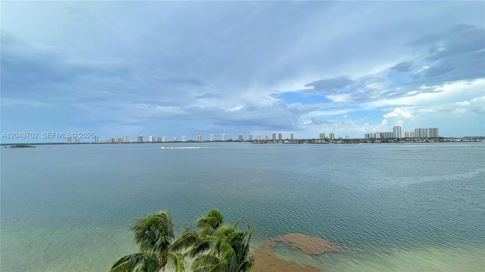 A view of a wide bay with distant buildings under a cloudy sky — 401 Lake Shore Dr # 801, Lake Park FL 33403, LAKE PARK, FL