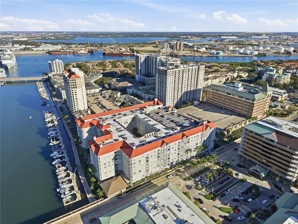 An aerial view shows a large apartment complex with a central courtyard and parking deck — 700 S HARBOUR ISLAND BOULEVARD UNIT 240, TAMPA, FL