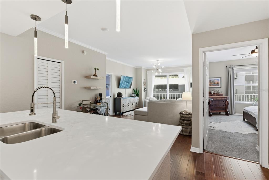 A kitchen island with a sink overlooks a living room and an adjacent bedroom — 700 S HARBOUR ISLAND BOULEVARD UNIT 240, TAMPA, FL