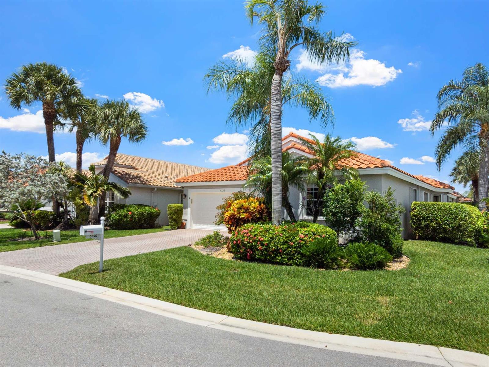 A single-story house with a tile roof, palm trees, and a paved driveway — 5320 Glenville Drive, Boynton Beach FL 33437, BOYNTON BEACH, FL