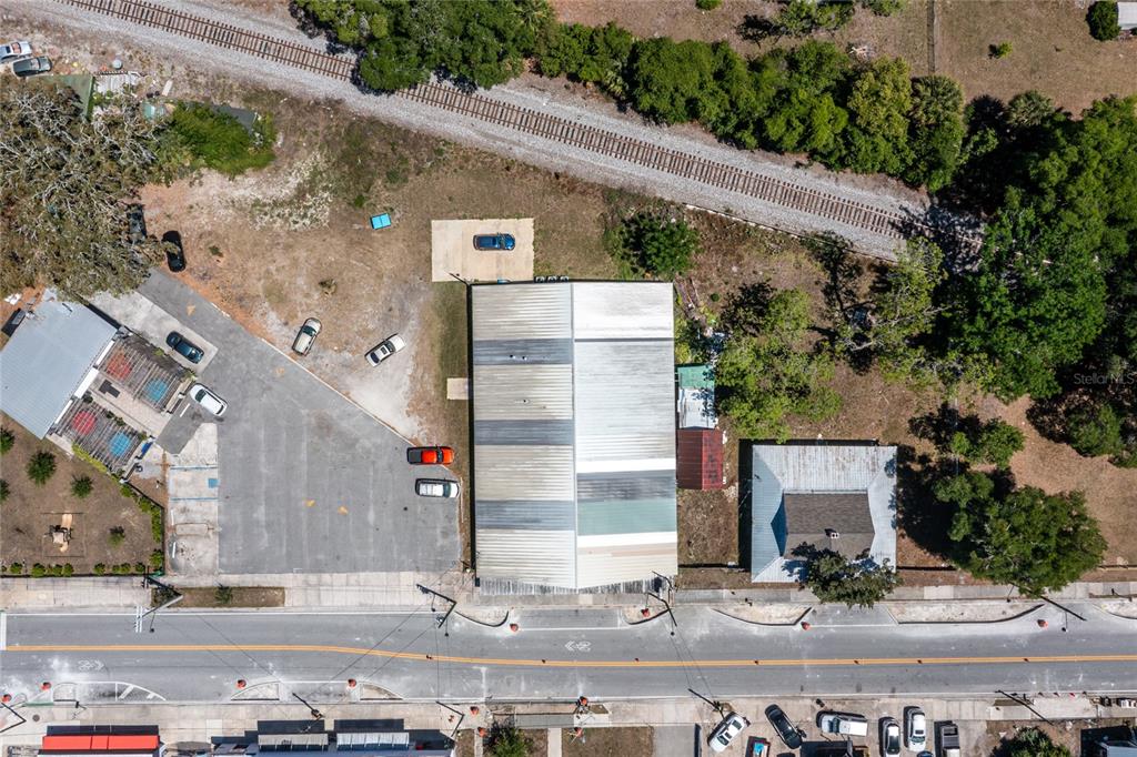 An aerial view shows a commercial building, a smaller structure, and a parking lot — 6945 SE 221ST STREET, HAWTHORNE, FL