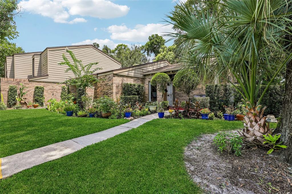 An entryway features white tile floors, a wooden console table, a mirror, and a window — 460 OAK HAVEN DRIVE, ALTAMONTE SPRINGS, FL