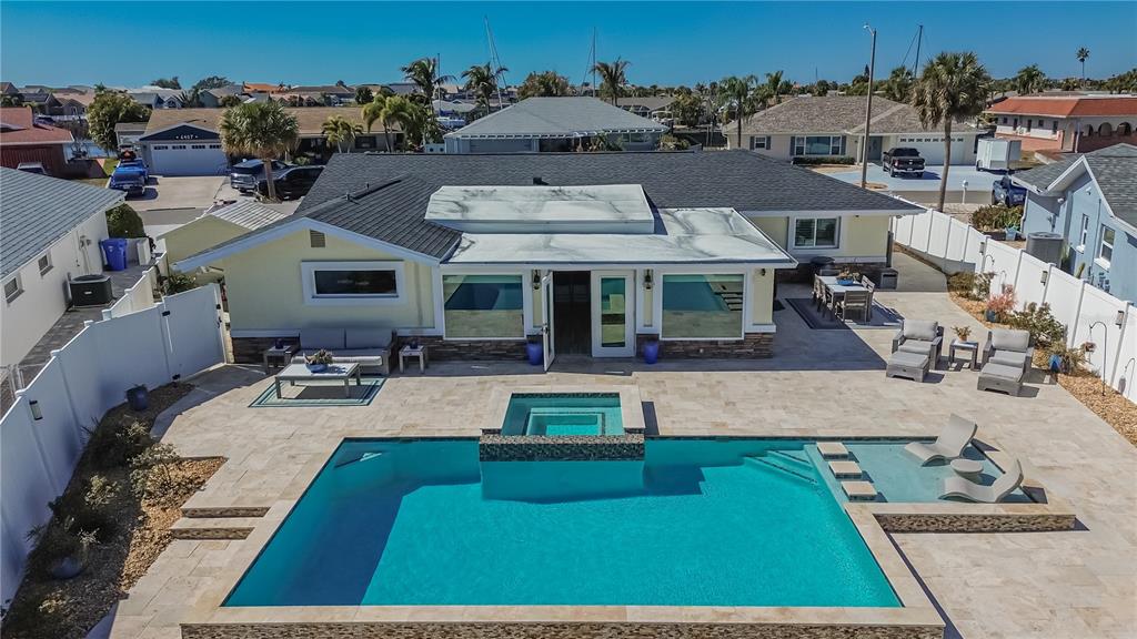 An aerial view of a backyard featuring a swimming pool, spa, and patio furniture — 6404 LAKE SUNRISE DRIVE, APOLLO BEACH, FL