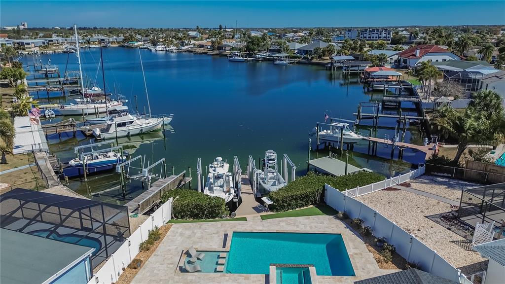 An aerial view of a waterfront property featuring a swimming pool and private boat docks — 6404 LAKE SUNRISE DRIVE, APOLLO BEACH, FL