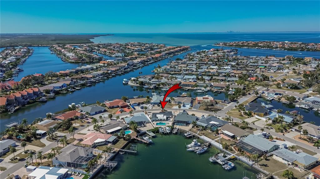 An aerial view shows a waterfront house with a pool and boat dock — 6404 LAKE SUNRISE DRIVE, APOLLO BEACH, FL