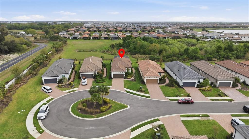 An aerial view shows a suburban street with several single-family homes and a cul-de-sac — 3015 TOLMINO COURT, BRADENTON, FL