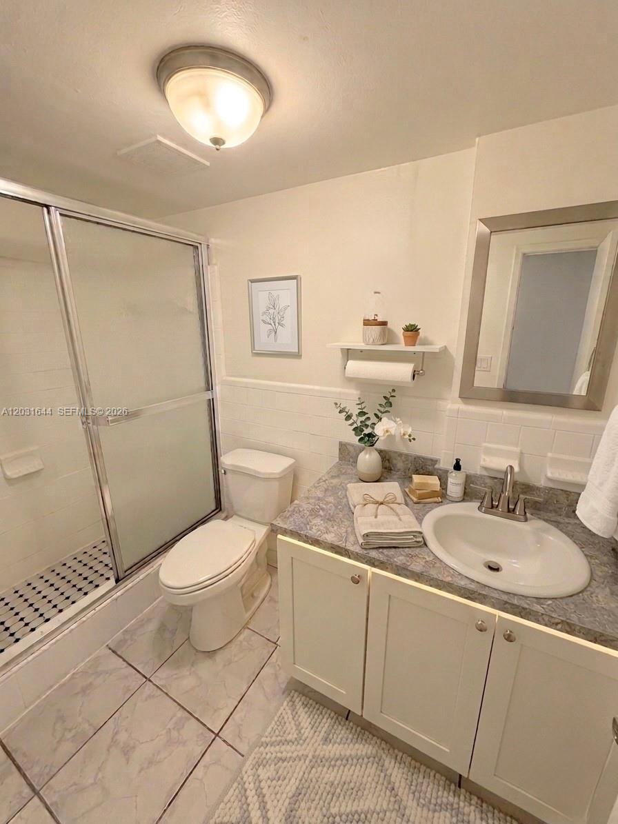 A bathroom features a walk-in shower, a toilet, and a vanity with a sink — 2745 W Okeechobee Rd # 5, Hialeah FL 33010, HIALEAH, FL