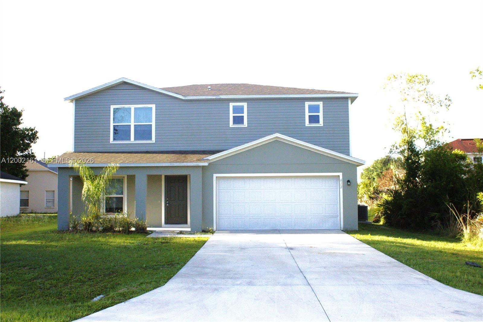 A two-story house with gray siding, a front porch, and an attached two-car garage — OTHER CITY - IN THE STATE OF FLORIDA, FL