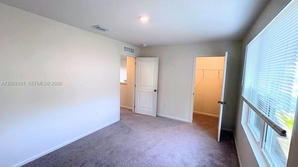 This bedroom features gray carpet, white walls, a closet, and a window with blinds — OTHER CITY - IN THE STATE OF FLORIDA, FL