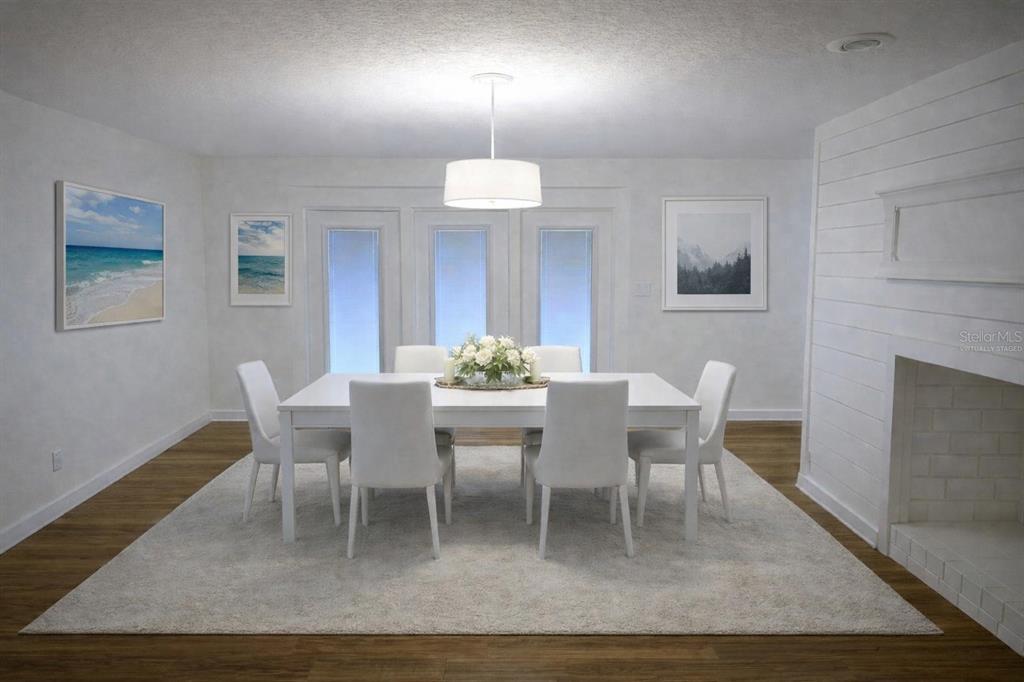 A dining room with a white table, six chairs, a rug, and a fireplace — 34041 HIGHLAND ROAD, LEESBURG, FL