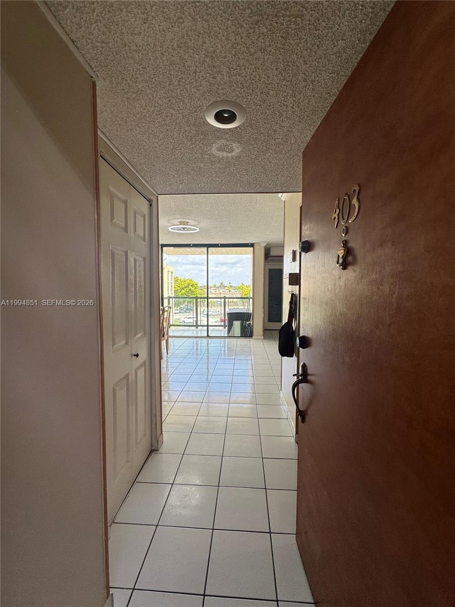 The view from an open apartment door shows a tiled entryway leading to a balcony — 2055 SW 122nd Ave # 403, Miami FL 33175, MIAMI, FL