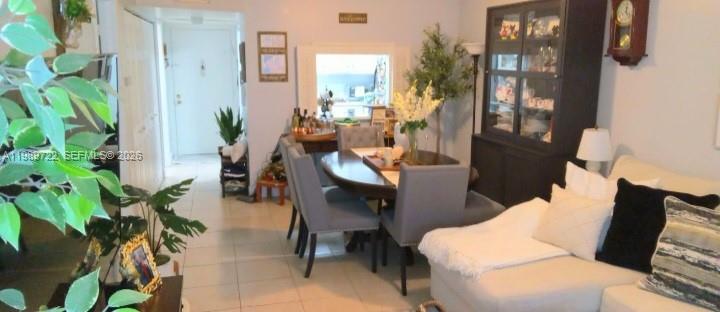 A dining area with a round table and chairs sits adjacent to a living room — 9273 SW 8th St # 220, Boca Raton FL 33428, BOCA RATON, FL
