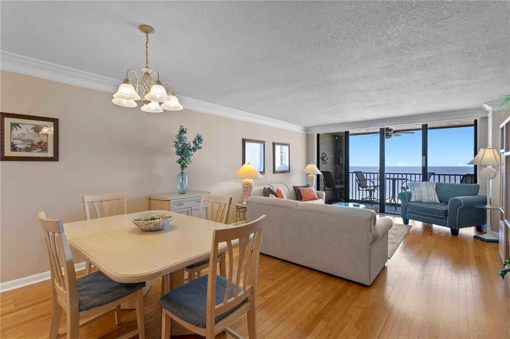 A balcony with patio furniture overlooks a sandy beach and the ocean — 1290 GULF BOULEVARD UNIT 1002, CLEARWATER, FL