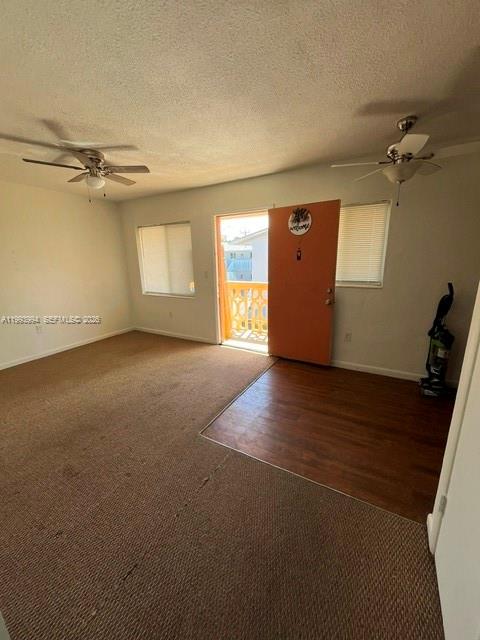 An interior room features beige carpeting, a wood-look floor section, and an orange exterior door — 1151 W 28th St # 9, Hialeah FL 33010, HIALEAH, FL