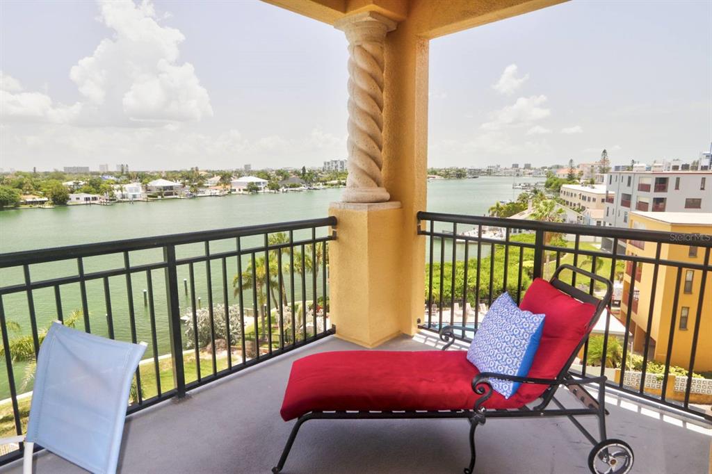 A balcony with a metal railing, a lounge chair, and a view of the water — 10315 GULF BOULEVARD UNIT 409, TREASURE ISLAND, FL
