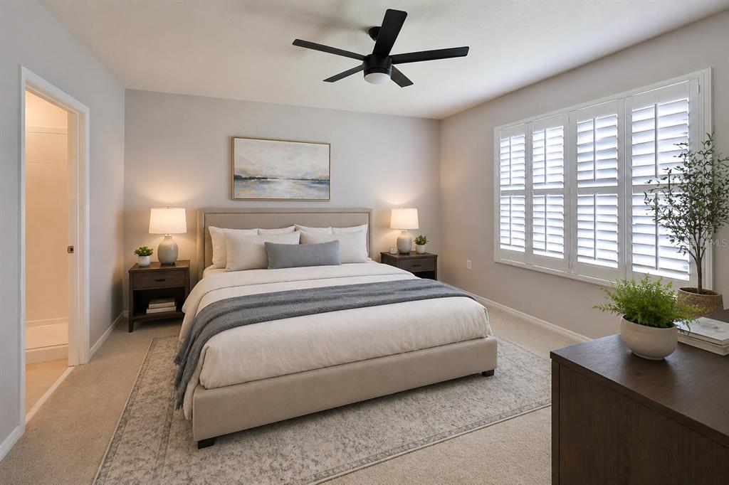 A bedroom features a bed with a grey throw, two nightstands, and plantation shutters — 349 CARYOTA COURT, NEW SMYRNA BEACH, FL