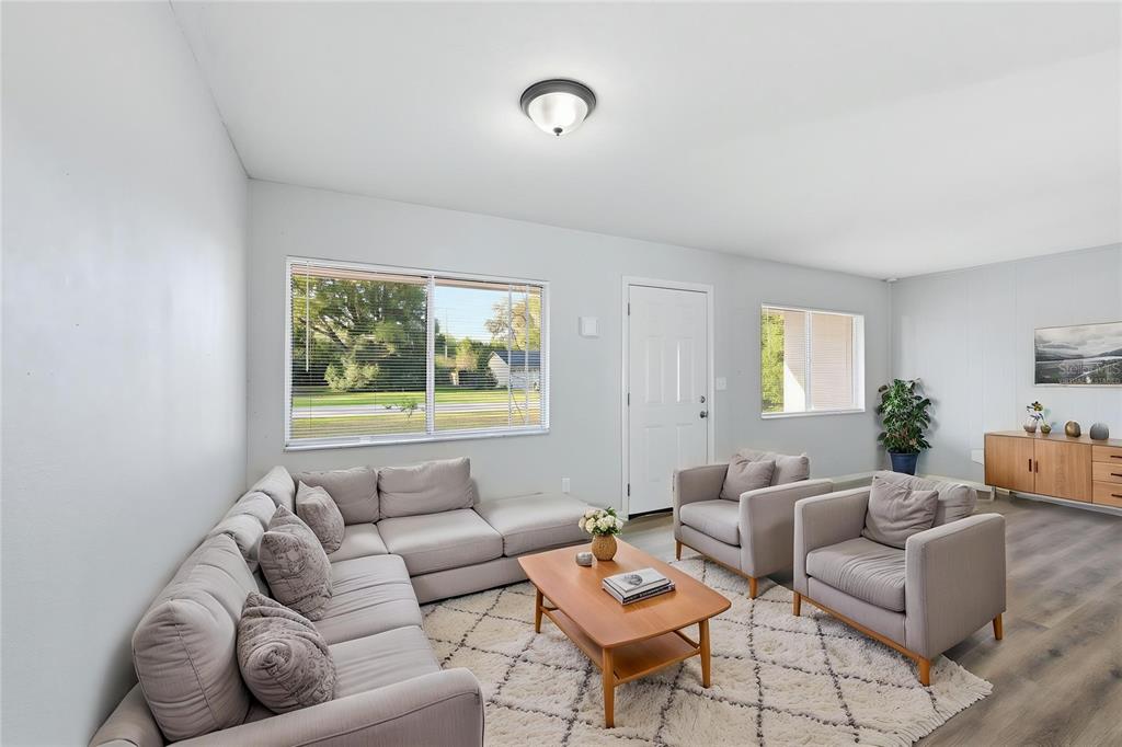 A living room features a sectional sofa, two armchairs, a coffee table, and light flooring — 170 W CRYSTAL LAKE AVENUE, LAKE MARY, FL