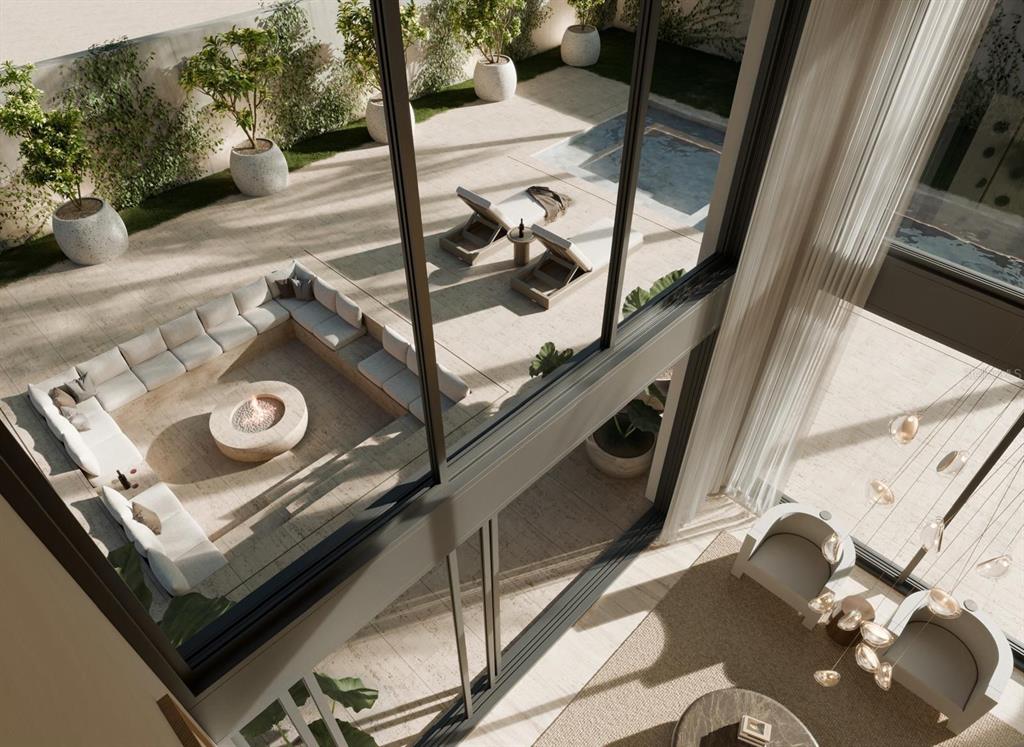 This is a rendering of a modern living room overlooking a patio with a fire pit — 45 SERENO, GUAYNABO, PR