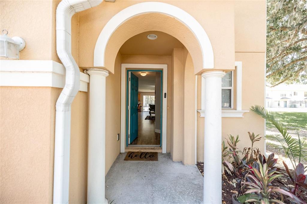 The exterior entrance features a tan stucco facade with a white arched entryway and columns — 4514 LIMERICK DRIVE, TAMPA, FL