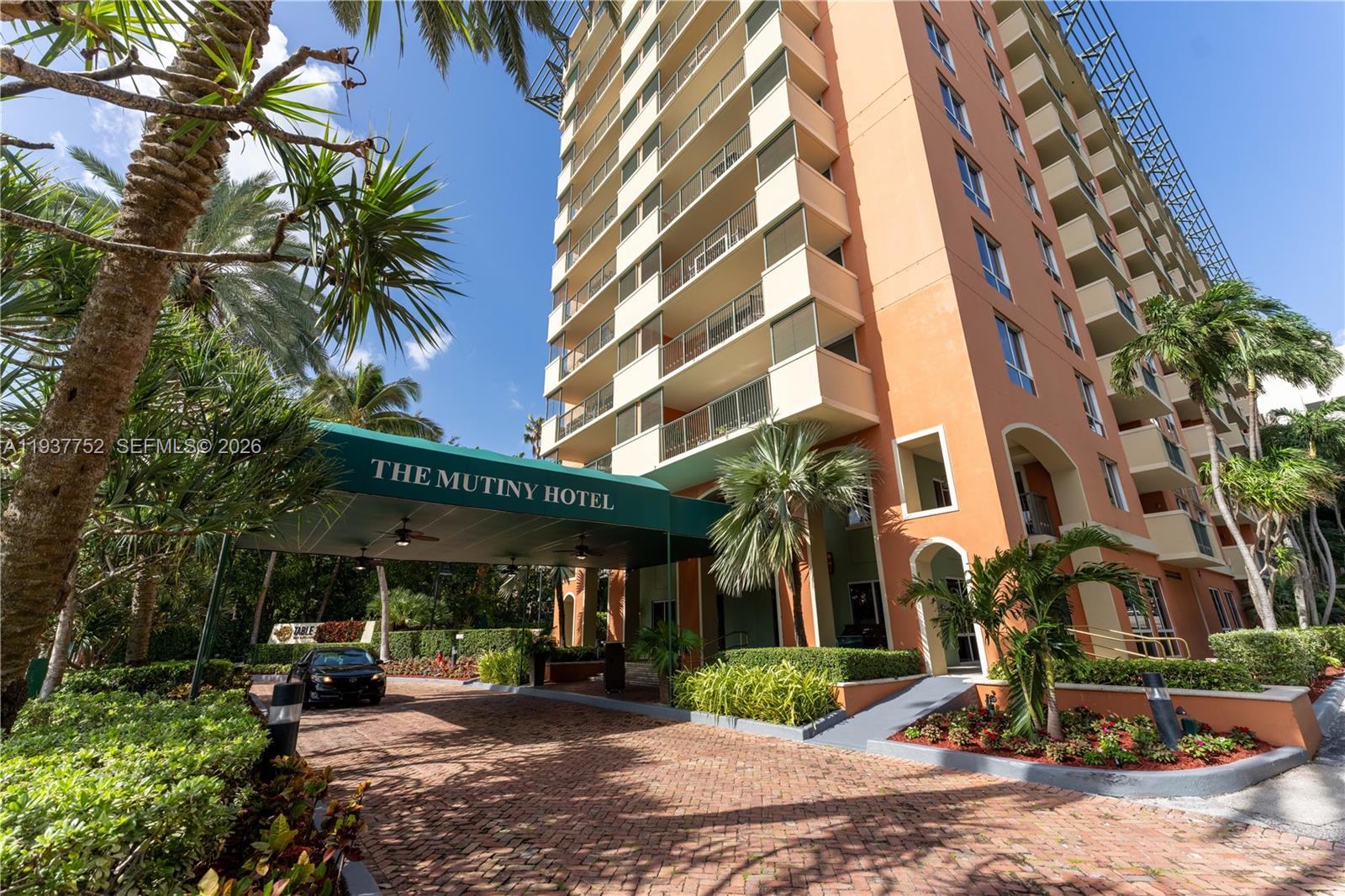 The exterior of The Mutiny Hotel features a brick driveway and a green entrance canopy — 2951 S Bayshore Dr # 717, Miami FL 33133, MIAMI, FL