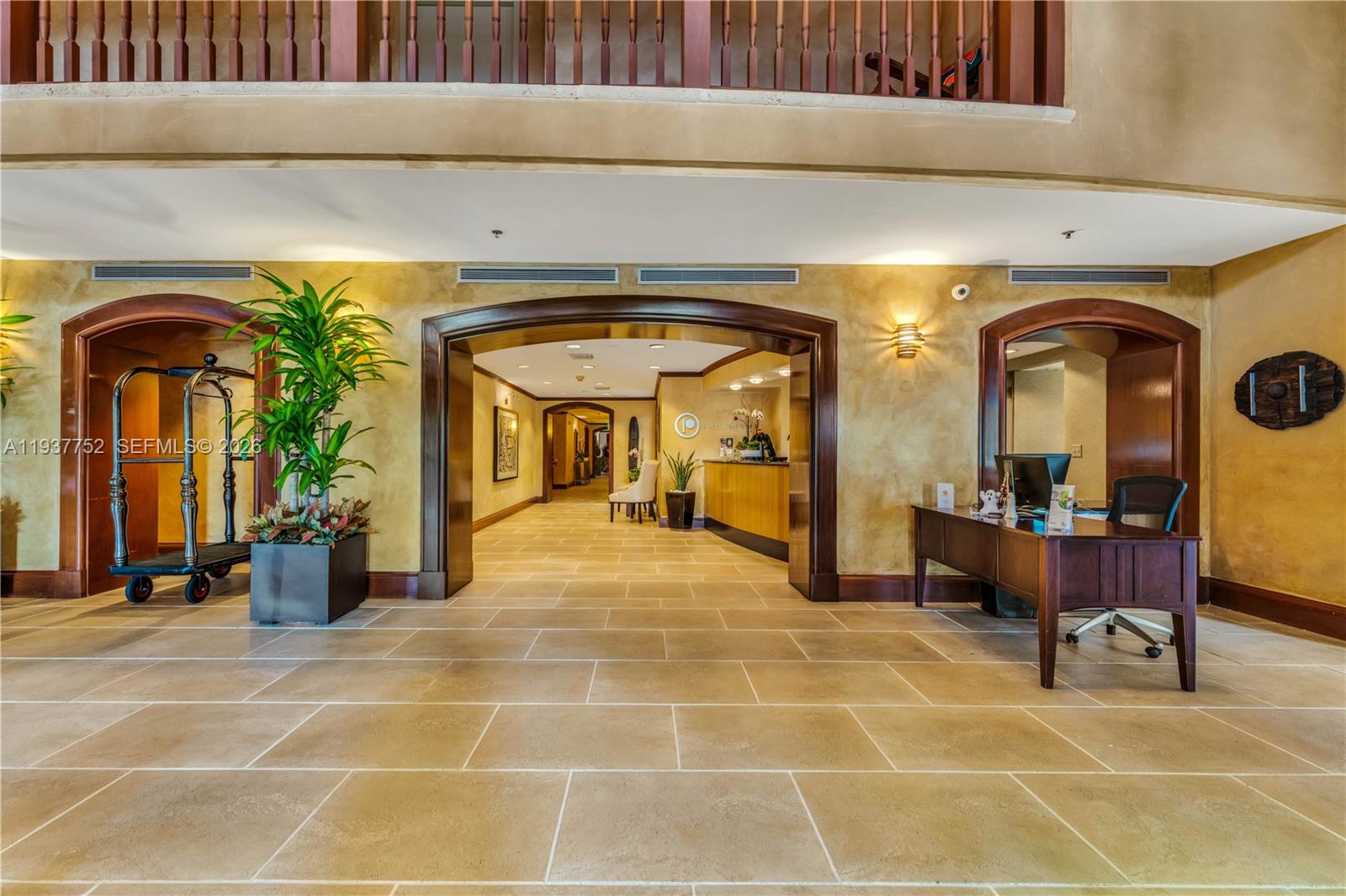 The lobby features a tiled floor, a reception desk, and arched entryways with wood trim — 2951 S Bayshore Dr # 717, Miami FL 33133, MIAMI, FL