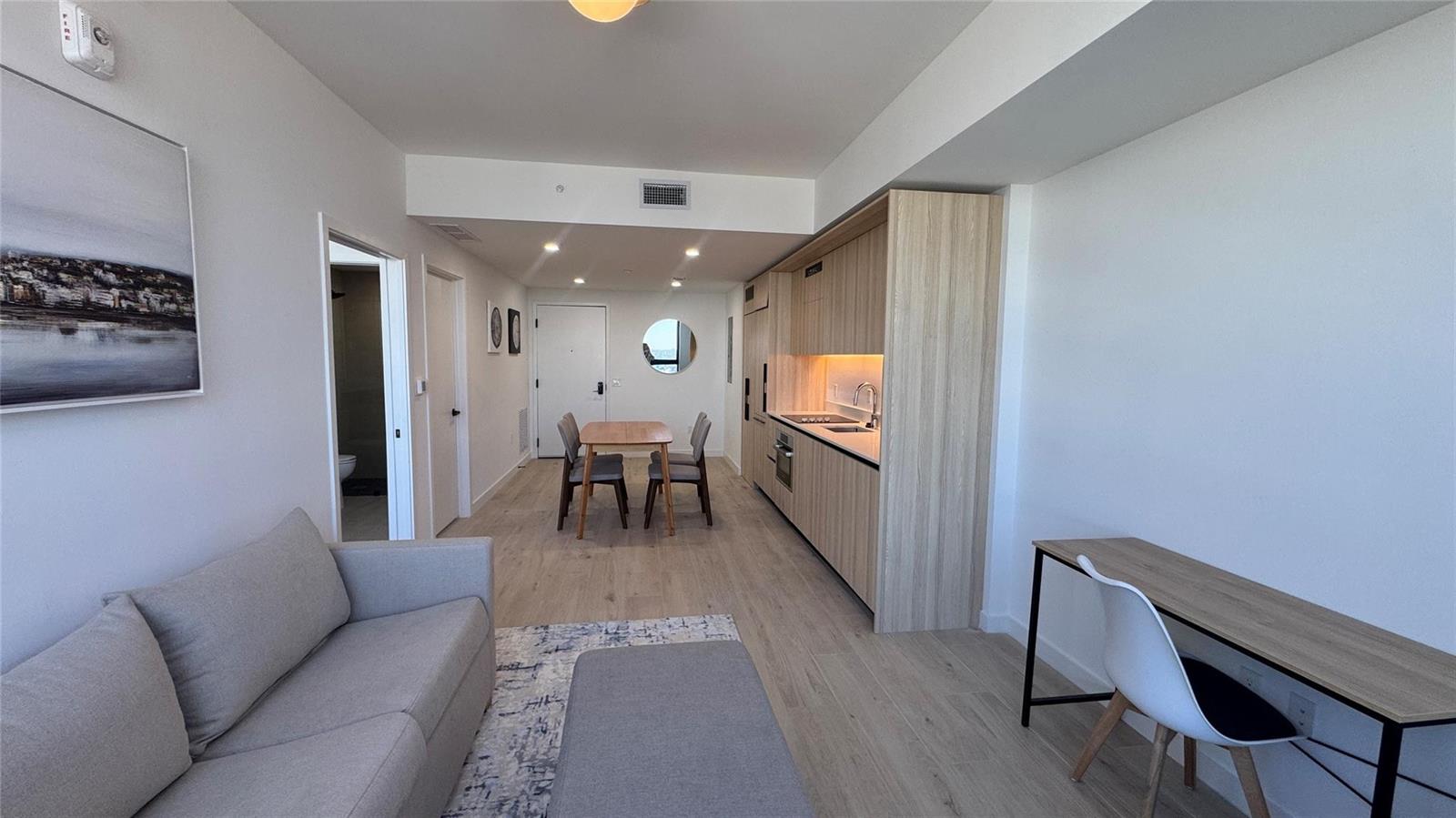 A modern studio apartment features a kitchen, dining area, living space, and a desk — 225 N Miami Avenue # 3604, Miami FL 33128, MIAMI, FL
